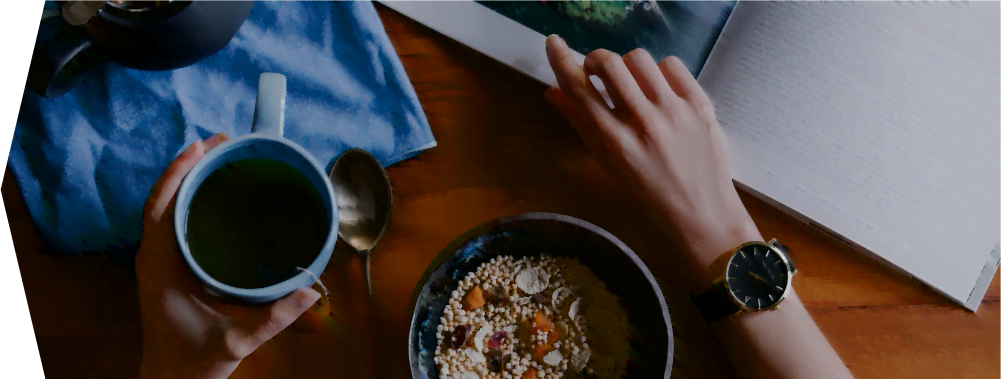 breakfast bowl, cup of tea and magazine on table